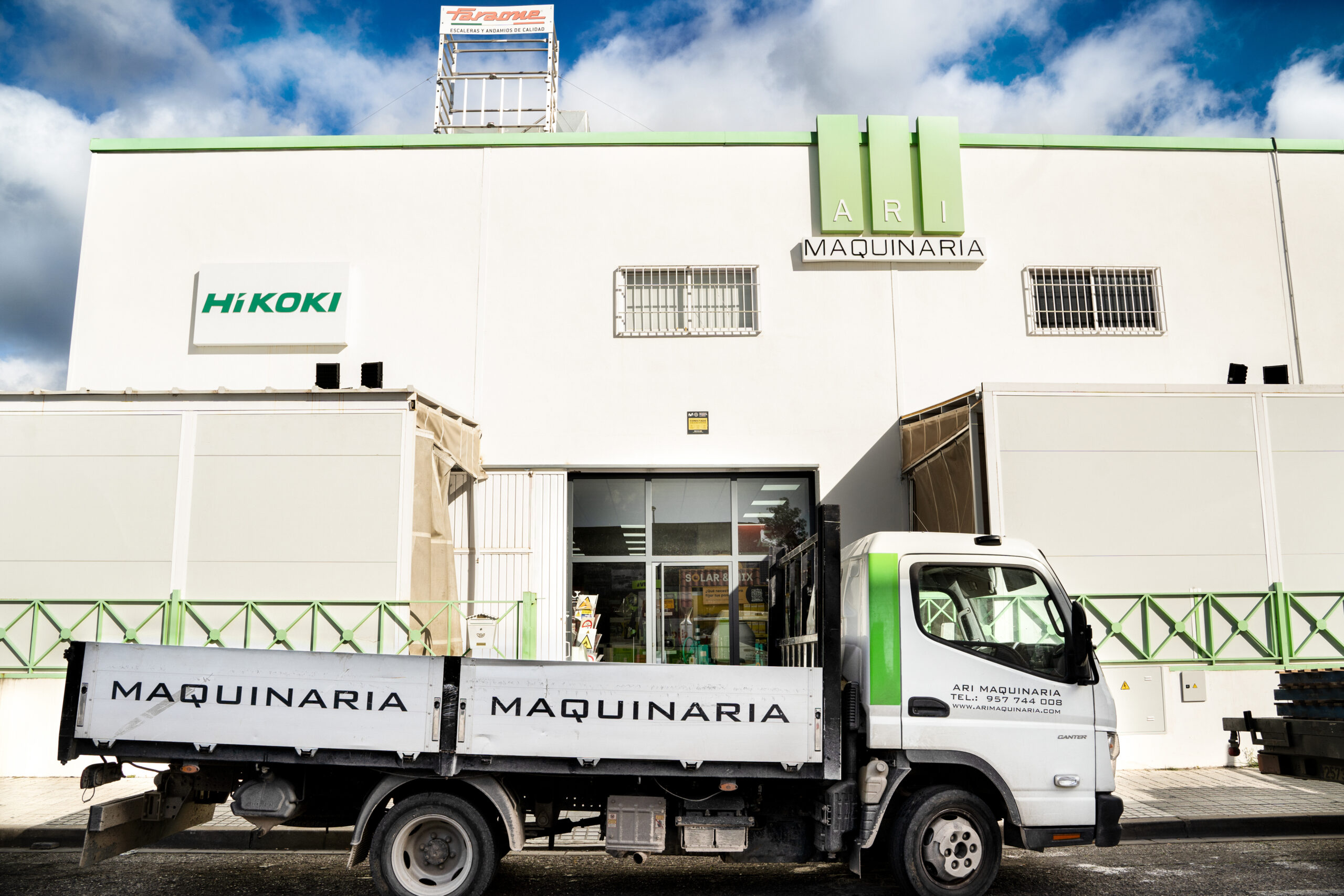 Fotografía completa de nuestro camión de carga frente a la nave industrial